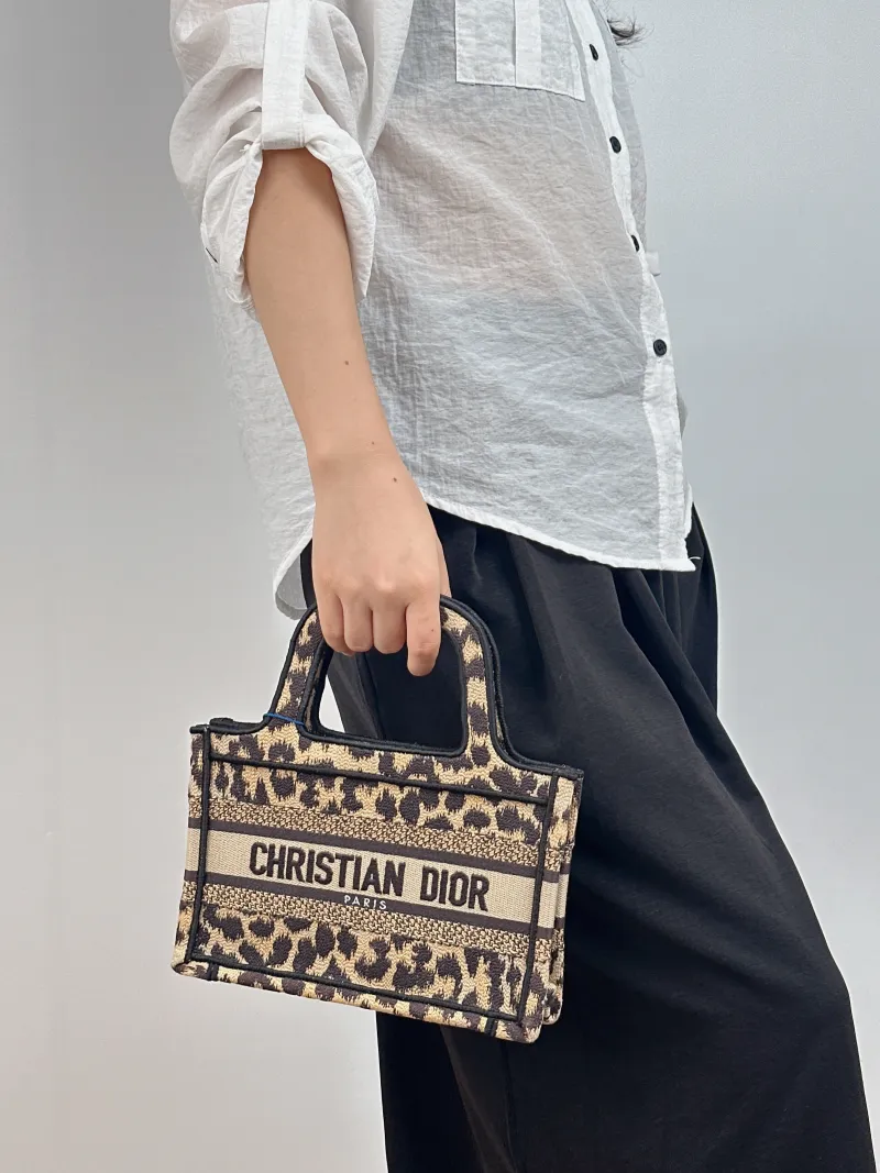 DIOR Top Handle Bag Book Tote Canvas Mini 22.5 × 6 × 15 cm — on-model view 1 of 2