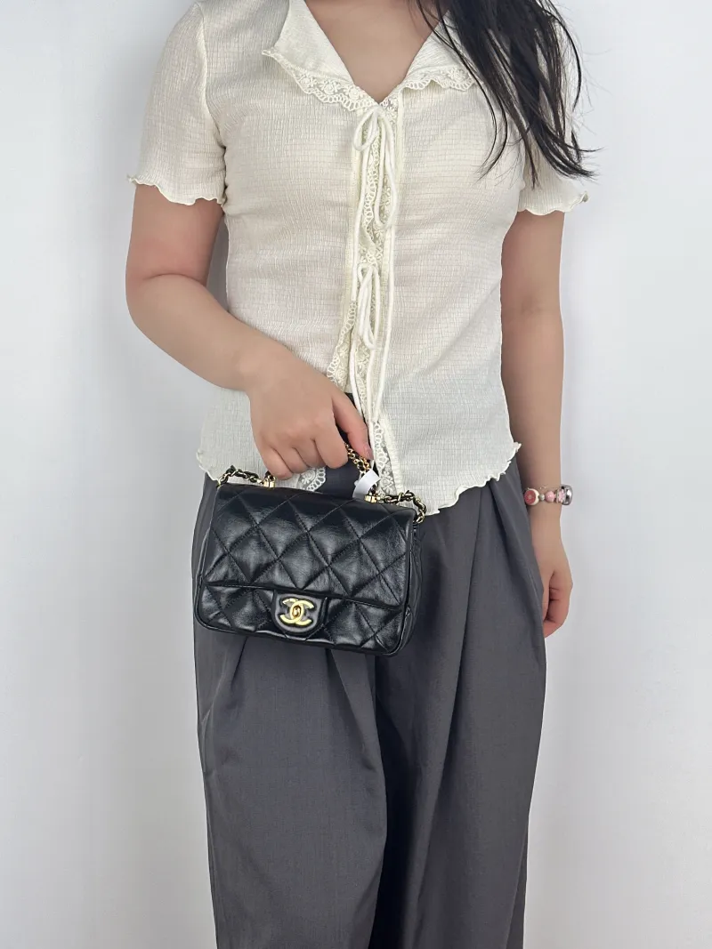 Chanel Crossbody Bag Black Lambskinmini19 × 8.5 × 14 cm — on-model view 2 of 3