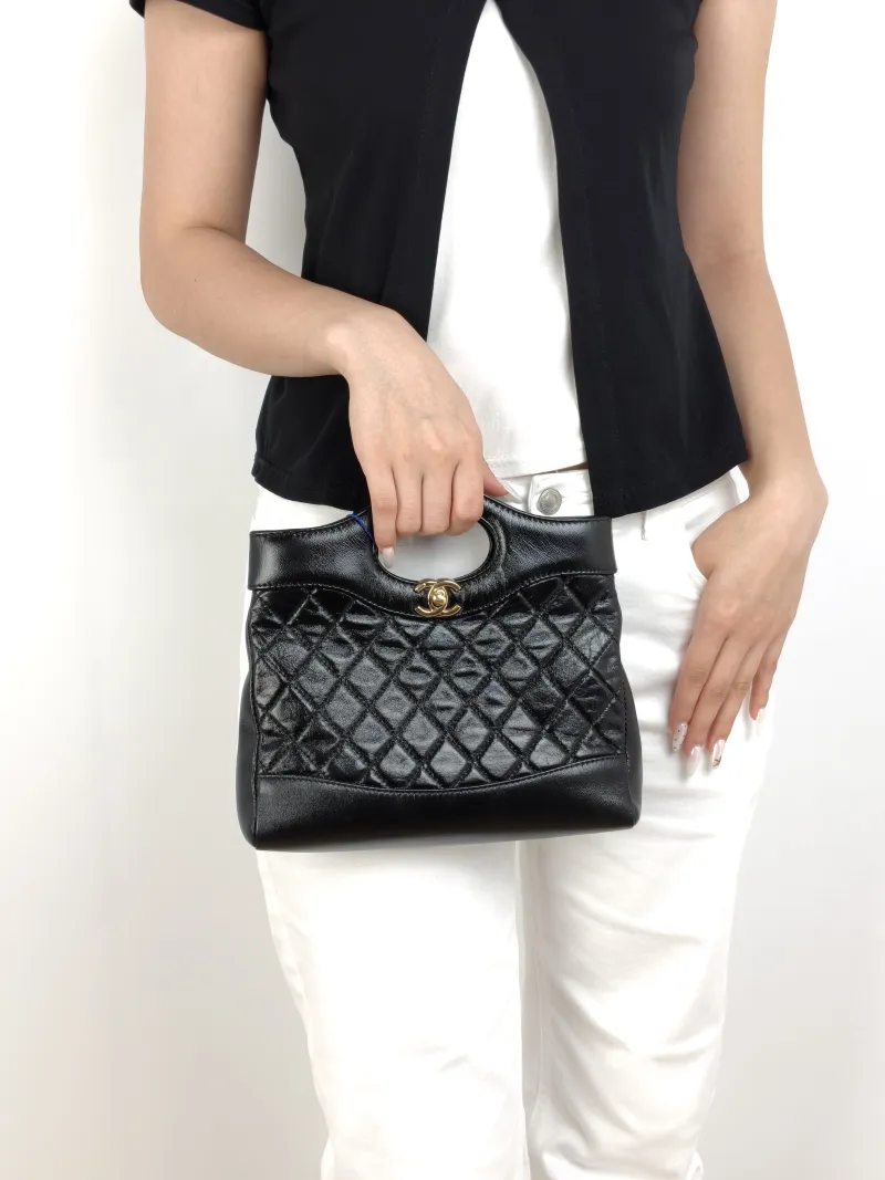Chanel Crossbody Bag31Bag Black Waxed Leathermini23 × 5.5 × 22 cm — on-model view 1 of 3