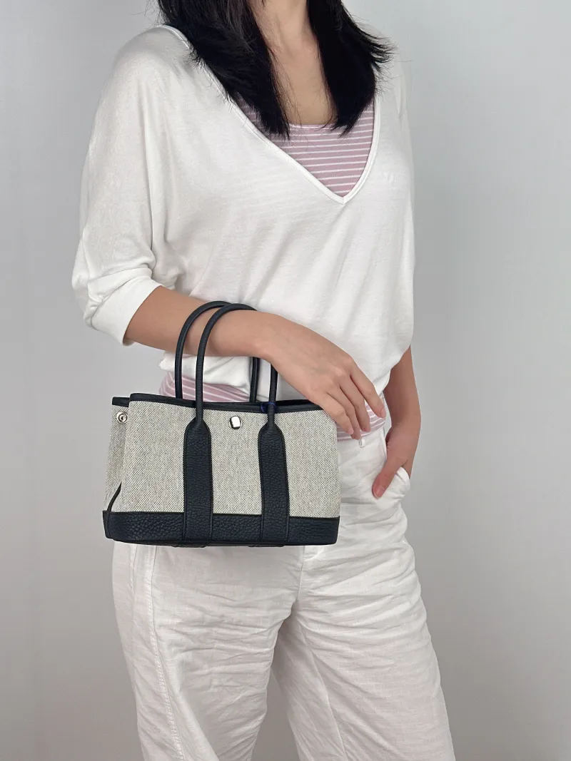 Hermès Top Handle Bag Neo Garden 23 Mini Black · Beige Canvas · Negonda Calfskin Mini 23 × 10 × 16 cm G — on-model view 2 of 2