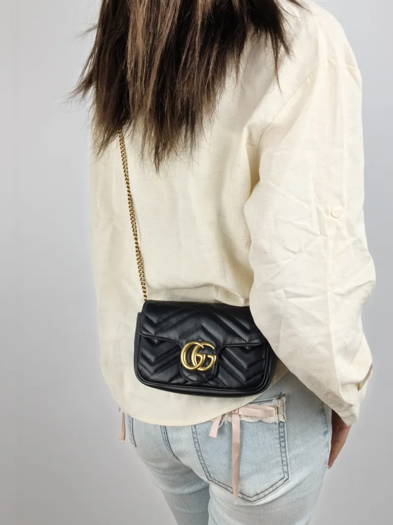 GUCCI Crossbody Bag GG Marmont Mini Marmont Mini Black Calfskin Mini 16.5 × 4.5 × 9.5 cm — on-model view 1 of 2