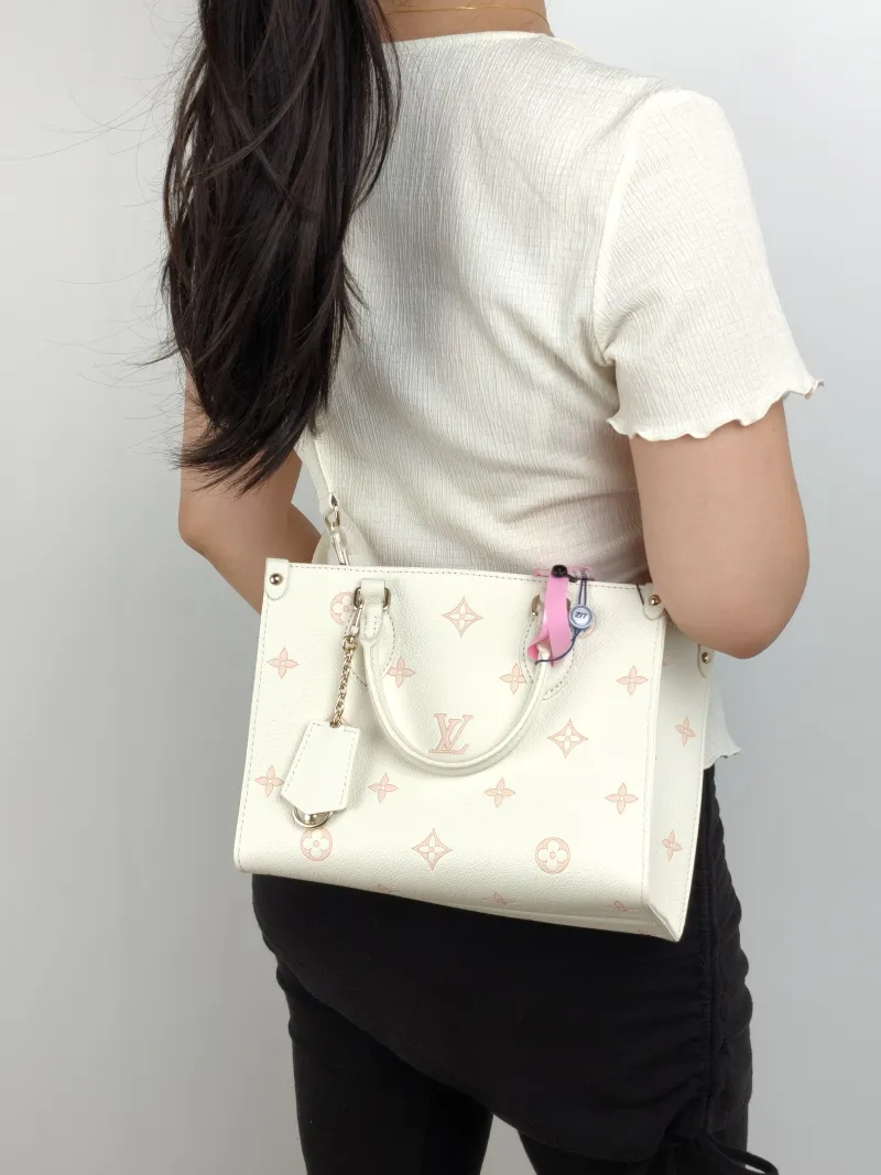 Louis Vuitton Shoulder Bag Onthego Beige · Pink Monogram Empreinte Embossed Calfskin Small 25 × 11.5 × 19 cm — on-model view 1 of 3