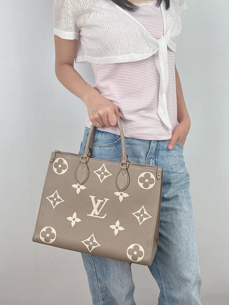 Louis Vuitton Shoulder Bag Onthego Medium · White Empreinte Embossed Calfskin Medium35 × 14 × 27 cm — on-model view 1 of 2