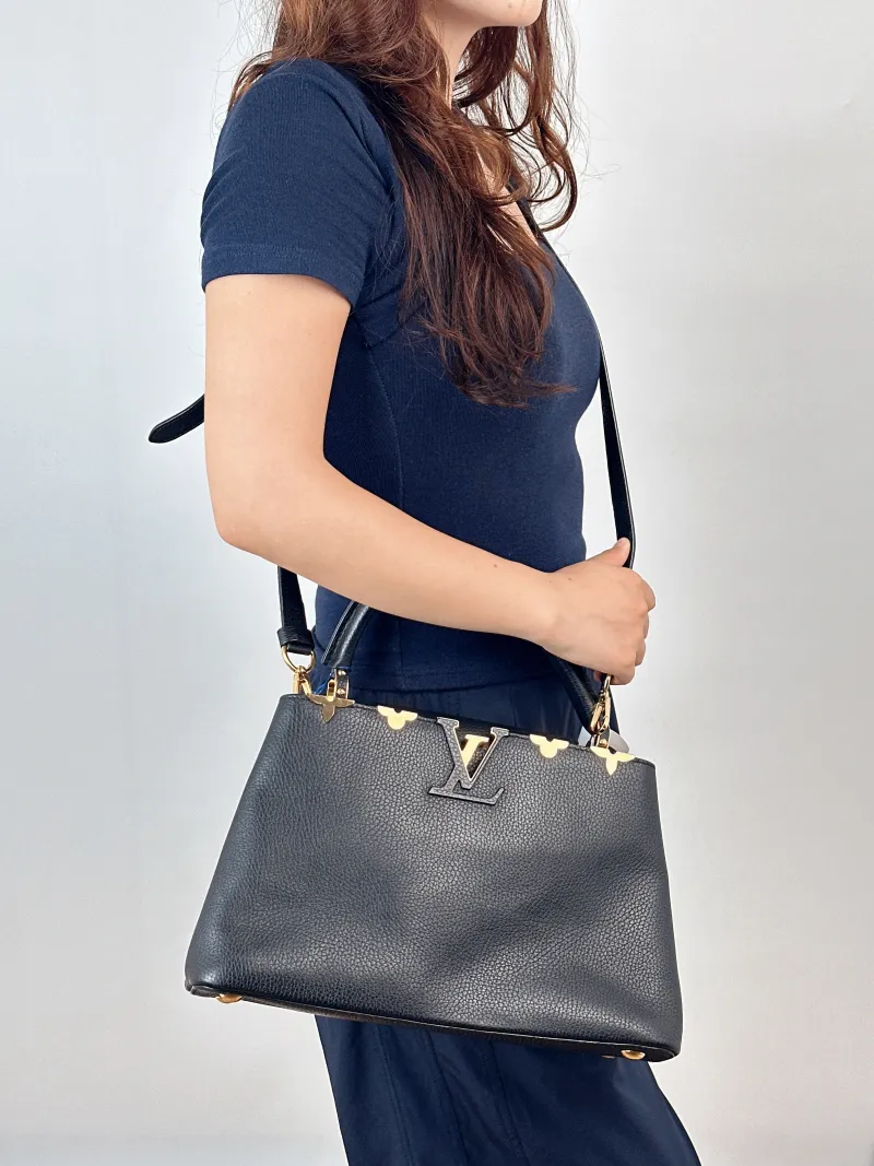 Louis Vuitton Top Handle Bag Capucines Black · Calfskin Medium31.5 × 11 × 20 cm — on-model view 2 of 2