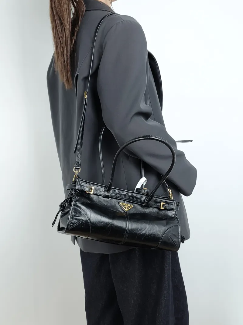 PRADA Shoulder Bag Bonnie Soft Lux Black Waxed Leather Medium 32 × 12 × 15.5 cm — on-model view 1 of 4
