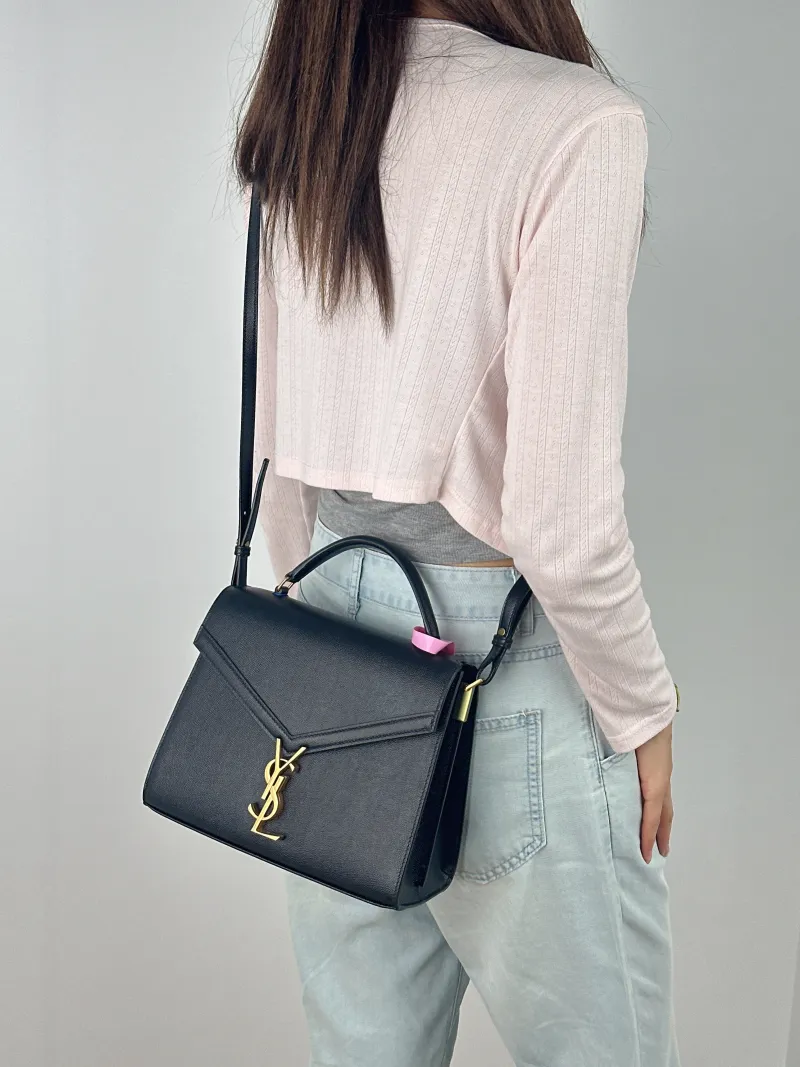SAINT LAURENT Shoulder Bag Cassandra Shoulder Bag Black with Gold-Tone Hardware Grained Calfskin Medium 24.5 × 11.5 × 20 cm — on-model view 1 of 3