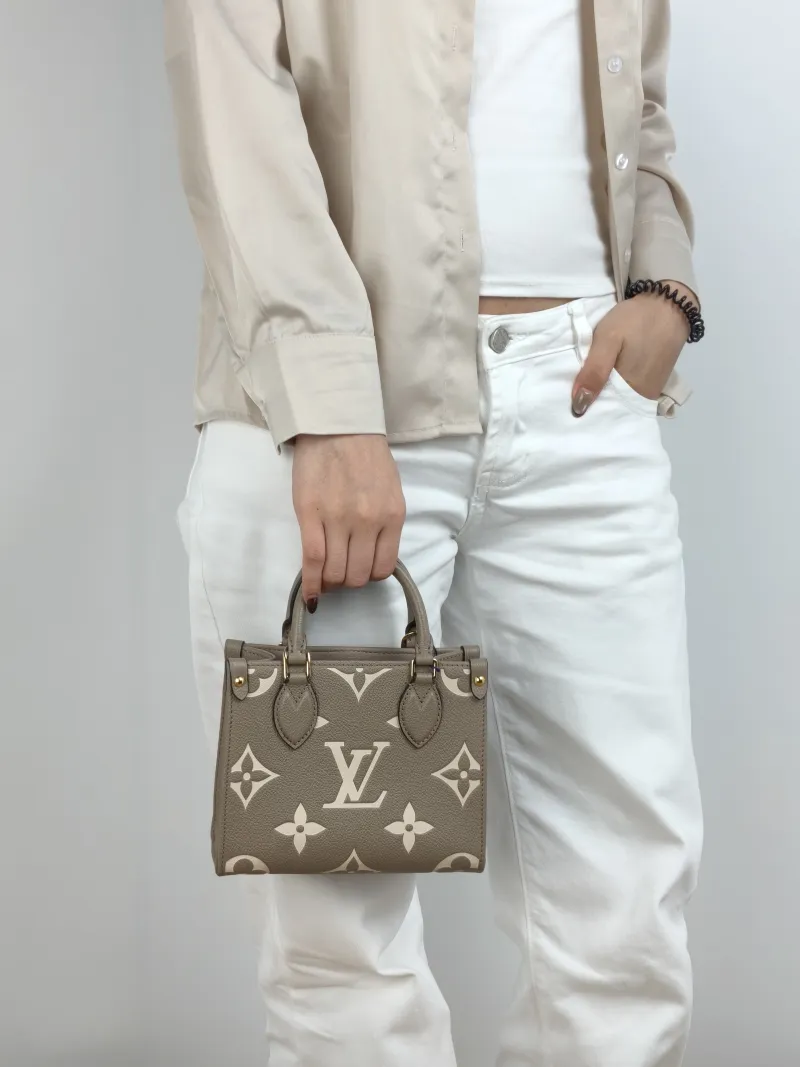 Louis Vuitton Crossbody Bag Onthego BB · White Monogram Empreinte Embossed Calfskin BB 18 × 8.5 × 15 cm — on-model view 1 of 3