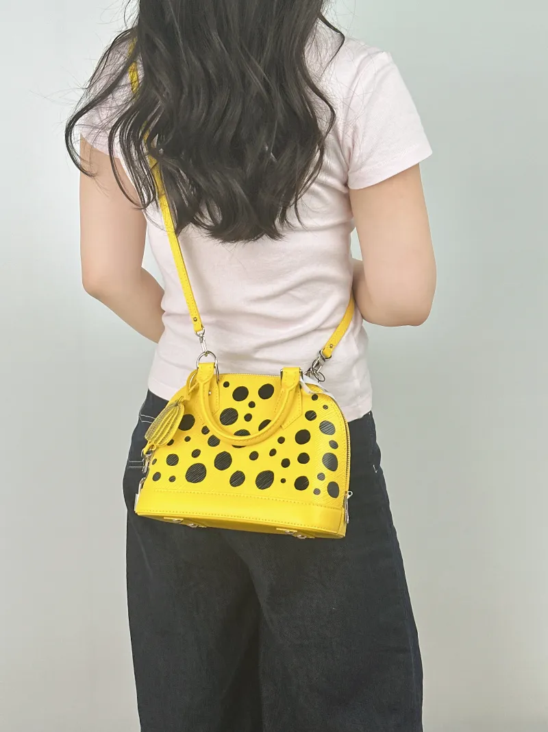 Louis Vuitton Top Handle Bag Alma BB Epi Embossed Calfskin BB 23.5 × 11.5 × 17.5 cm — on-model view 1 of 2