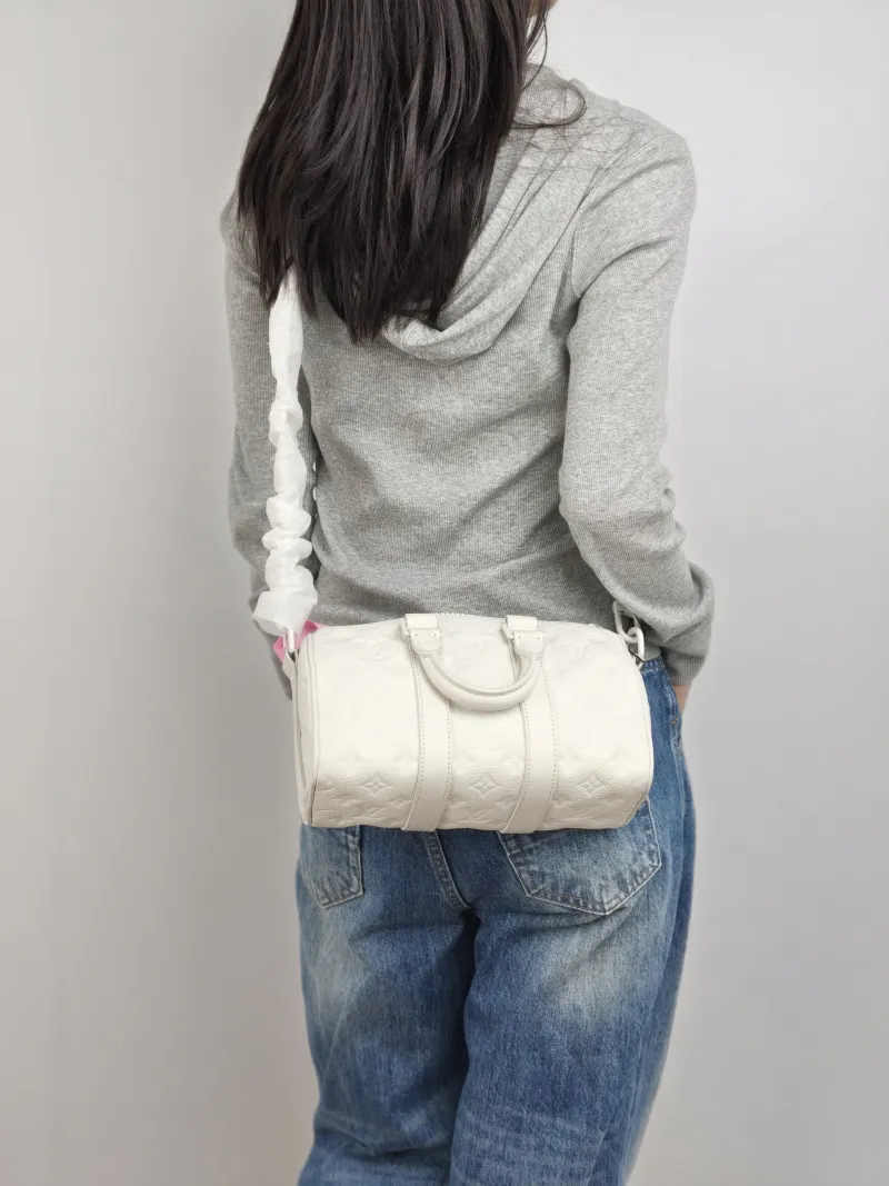 Louis Vuitton Crossbody Bag Keepall 25 White Calfskin Medium 25 × 11 × 15 cm — on-model view 1 of 3