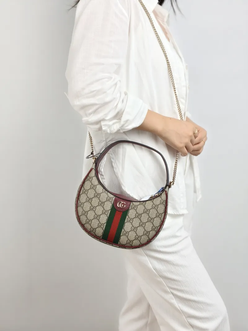 GUCCI Crossbody Bag Ophidia GG Monogram PVC Small 20 × 5 × 11 cm — on-model view 1 of 2
