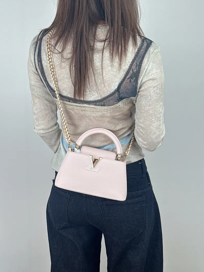 Louis Vuitton Top Handle Bag Capucines East West Pink Calfskinmini22 × 8 × 12 cm — on-model view 1 of 3