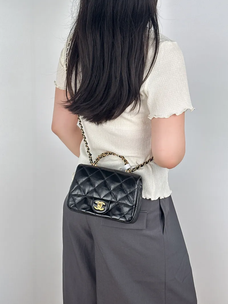 Chanel Crossbody Bag Black Lambskinmini19 × 8.5 × 14 cm — on-model view 1 of 3