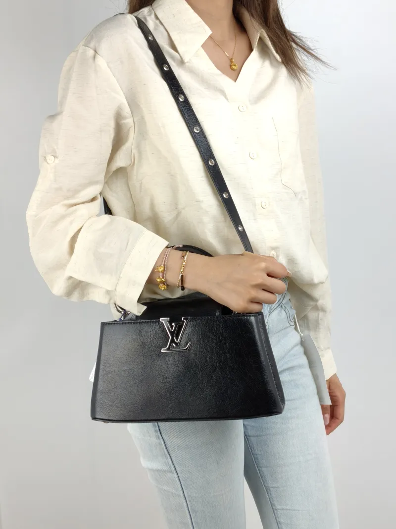 Louis Vuitton Crossbody Bag Capucines East West Black Calfskin BB 26.5 × 8 × 14 cm — on-model view 1 of 3