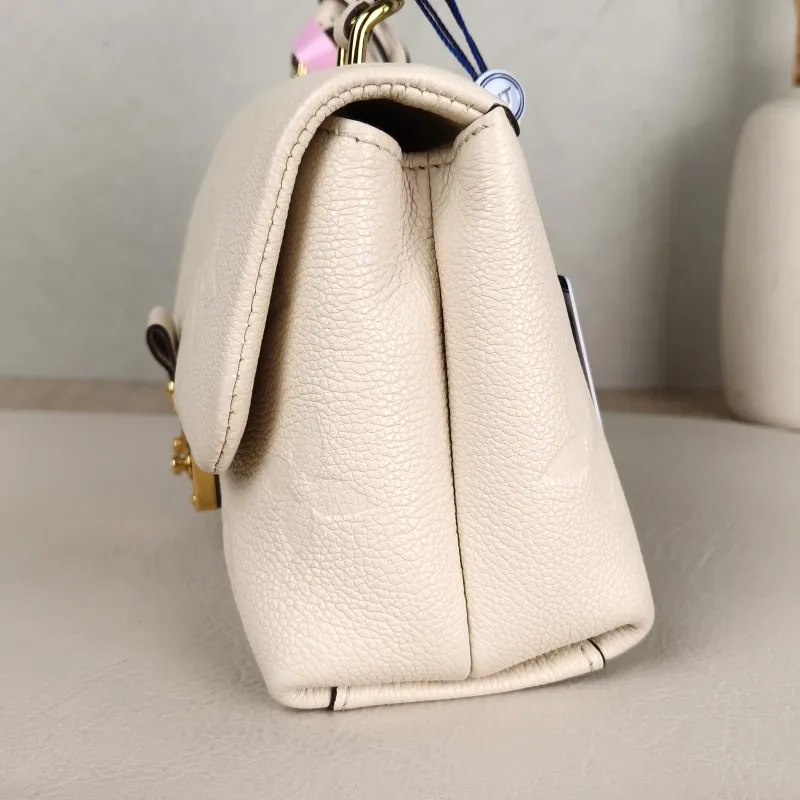 Louis Vuitton Crossbody Bag MADELEINE White Monogram Empreinte Embossed Calfskin BB 24 × 8.5 × 17 cm — detail view 13 of 14