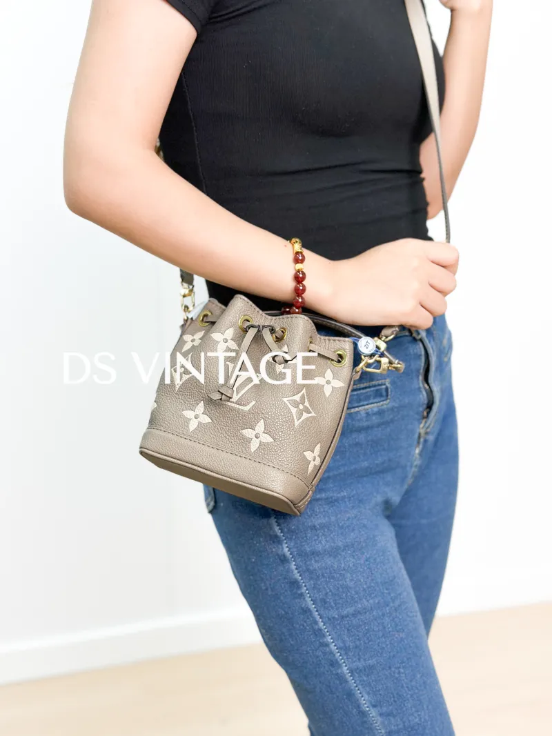 Louis Vuitton Crossbody Bag NANO NOÉ Bucket Bag Nano · White Monogram Empreinte Embossed Calfskin nano 13 × 10 × 16 cm — on-model view 2 of 3