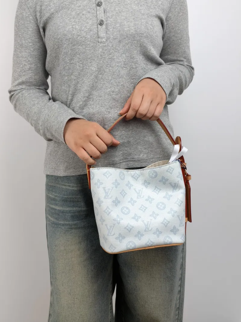 Louis Vuitton Top Handle Bag ALL IN BB Blue PVC BB 16 × 12 × 18 cm — on-model view 1 of 3