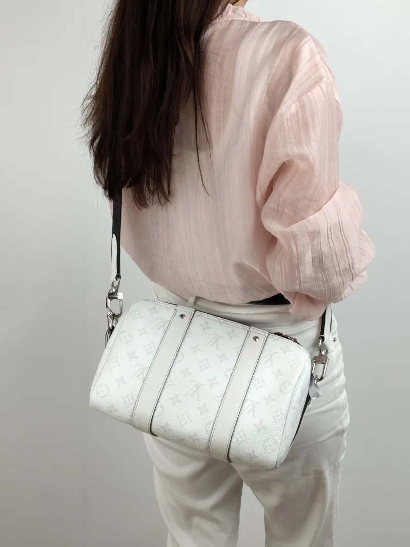 Louis Vuitton Crossbody Bag City Keepall White PVC Medium 27 × 13 × 17 cm — on-model view 1 of 2