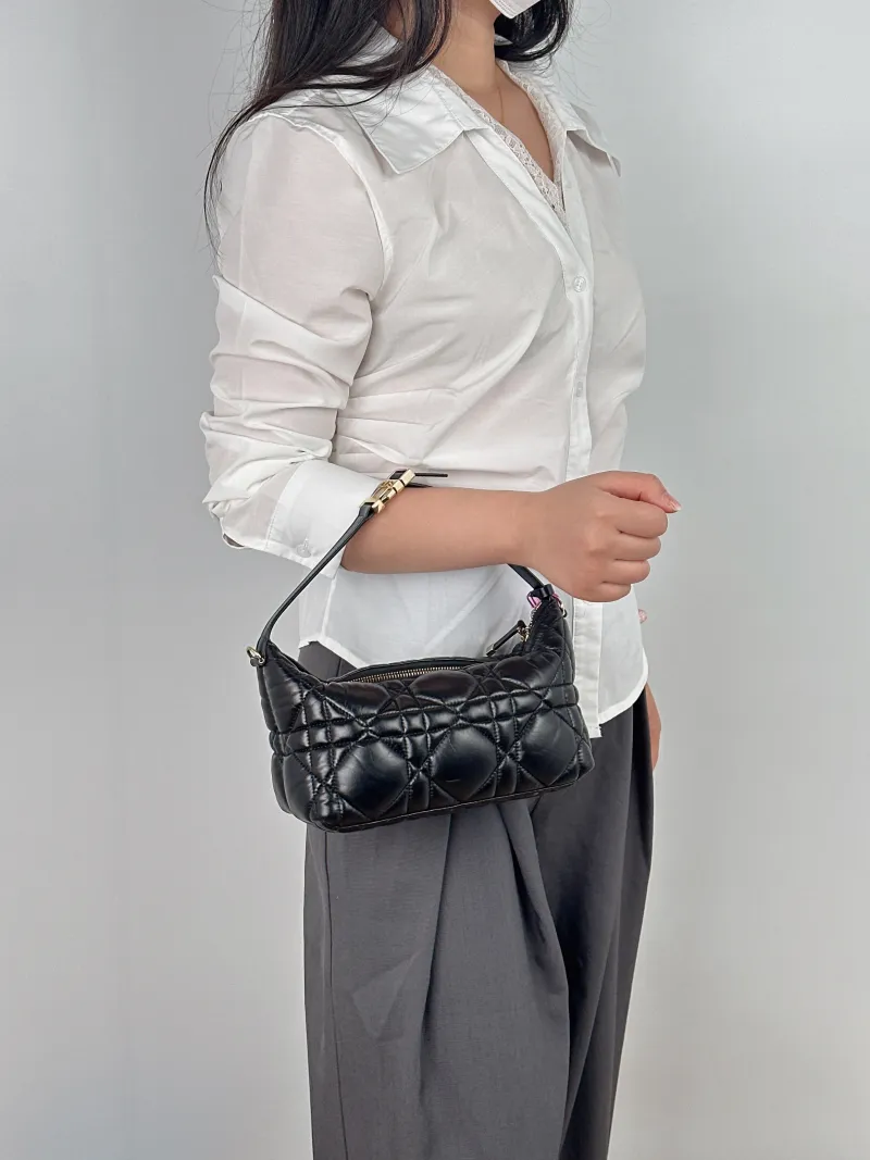 DIOR Top Handle Bag Travel Nomad Black Calfskin Medium 22 × 9.5 × 13 cm — on-model view 1 of 2