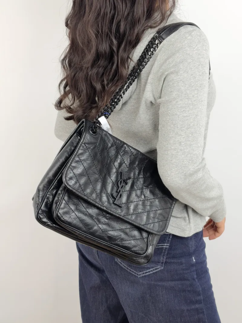 SAINT LAURENT Crossbody Bag Niki Black Waxed Leather Calfskin Medium 28 × 8.5 × 20 cm — on-model view 3 of 3