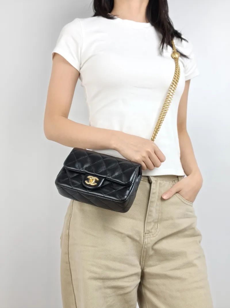 Chanel Crossbody Bag Black with Gold-Tone Hardware Lambskin Mini 18 × 5 × 12 cm — on-model view 1 of 2