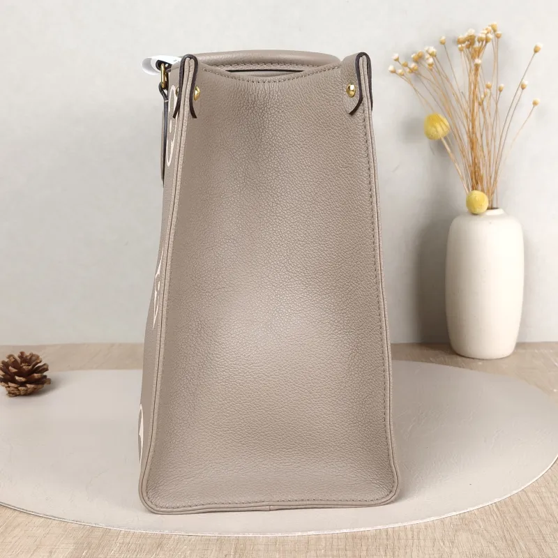 Louis Vuitton Shoulder Bag Onthego Medium · White Monogram Empreinte Embossed Calfskin Medium 35 × 14 × 27 cm — detail view 11 of 11
