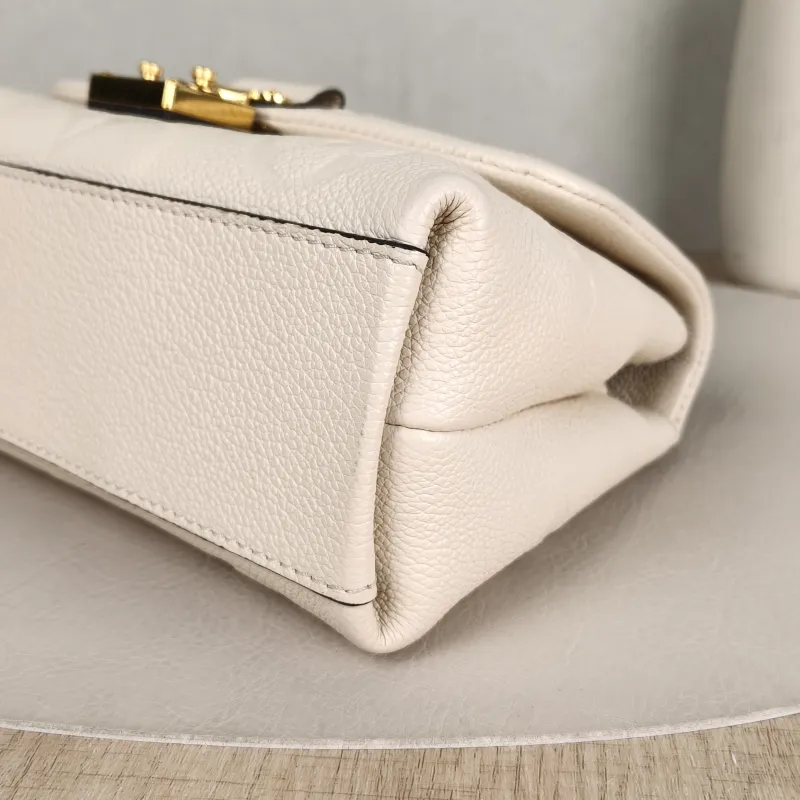 Louis Vuitton Crossbody Bag MADELEINE White Monogram Empreinte Embossed Calfskin BB 24 × 8.5 × 17 cm — detail view 1 of 14