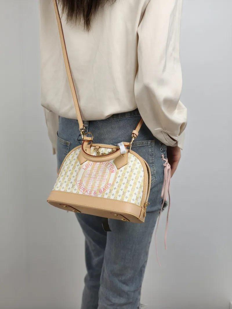 Louis Vuitton Top Handle Bag Alma BB Yellow White Canvas BB 23.5 × 11.5 × 17.5 cm — on-model view 1 of 2