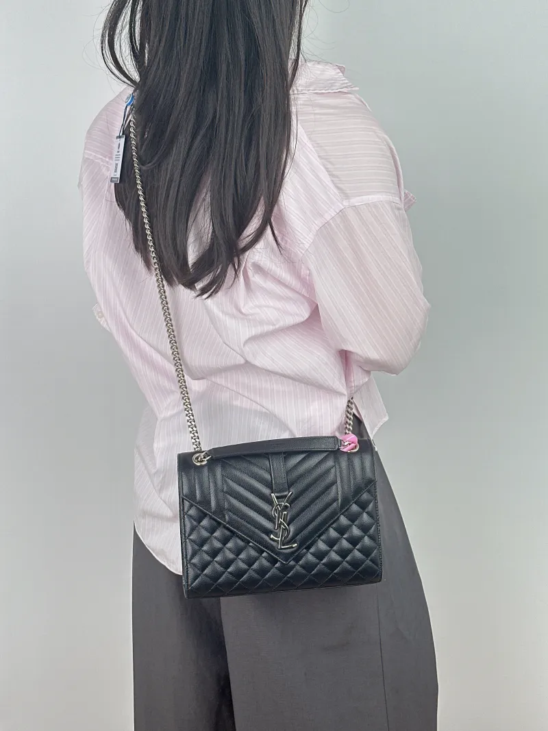 SAINT LAURENT Crossbody Bag ENVELOPE Black Calfskin Medium 24 × 6 × 17.5 cm — on-model view 1 of 2