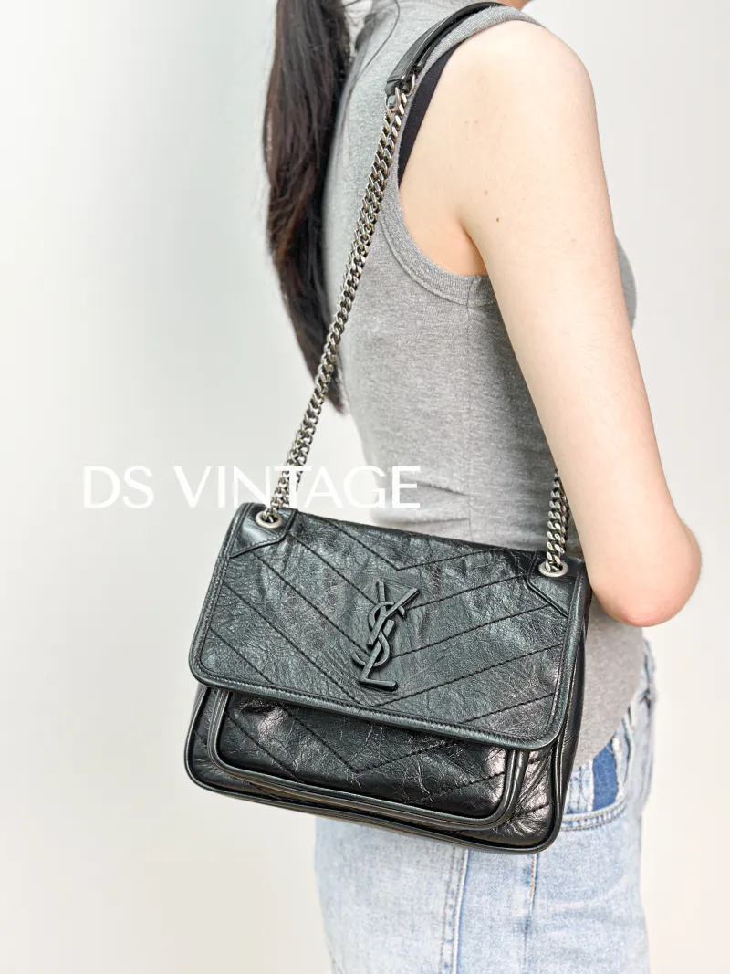 SAINT LAURENT Crossbody Bag Niki Black Waxed Leather Calfskin Small 21 × 7.5 × 16 cm — on-model view 1 of 3