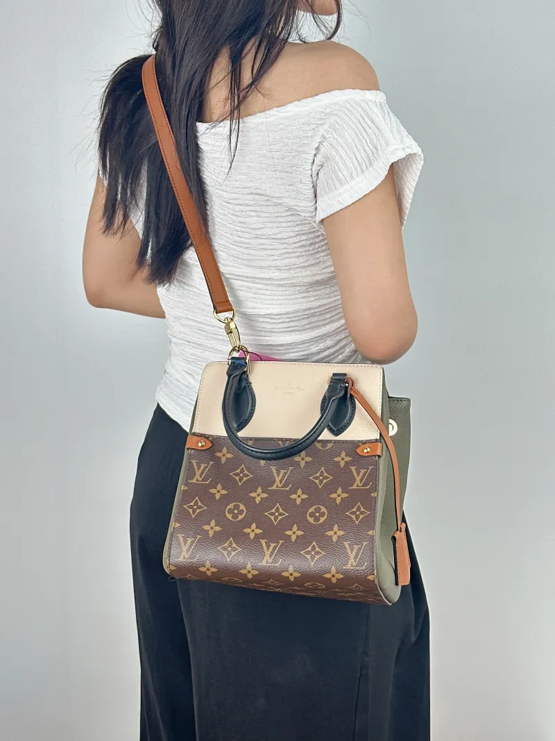 Louis Vuitton Top Handle Bag Fold Tote Colorblock PVC · Calfskin Small 20 × 18 × 22 cm — on-model view 1 of 2