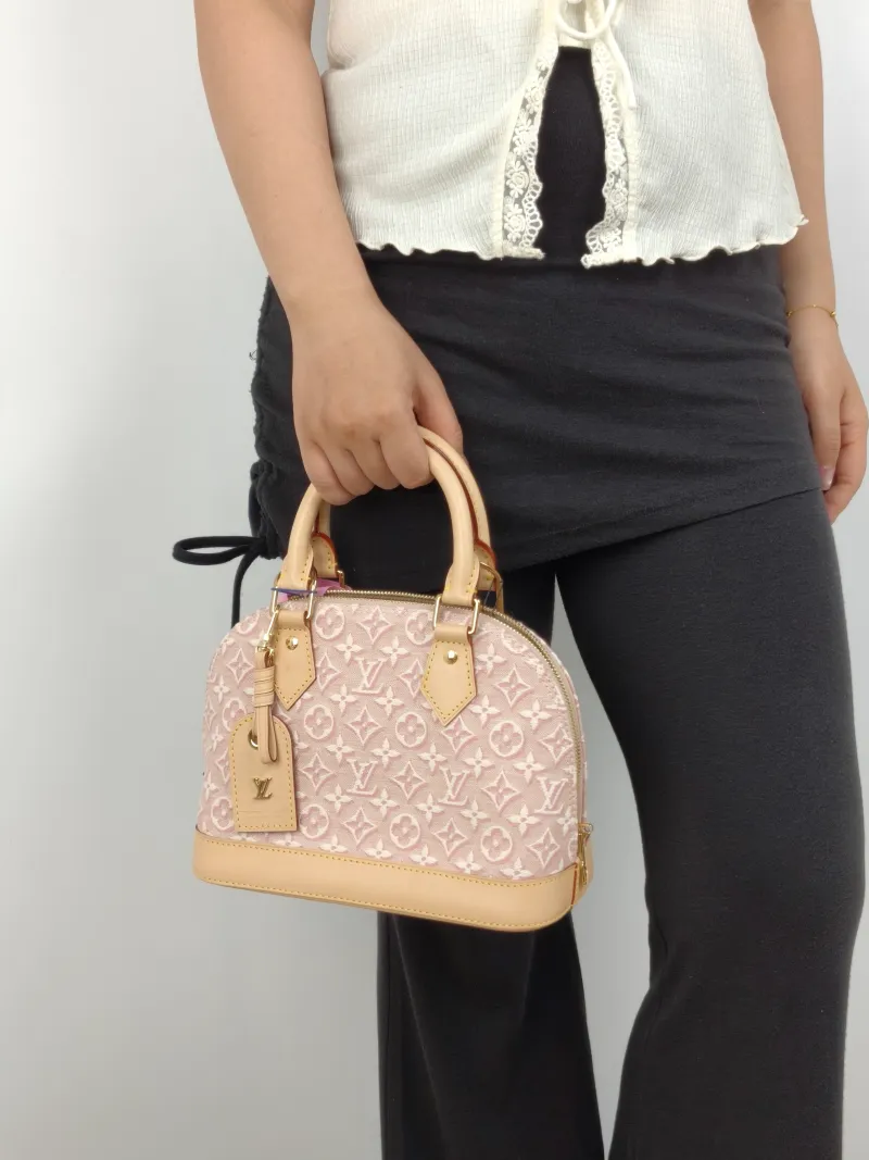 Louis Vuitton Top Handle Bag Alma BB Pink BB 23.5 × 11.5 × 17.5 cm — on-model view 2 of 3
