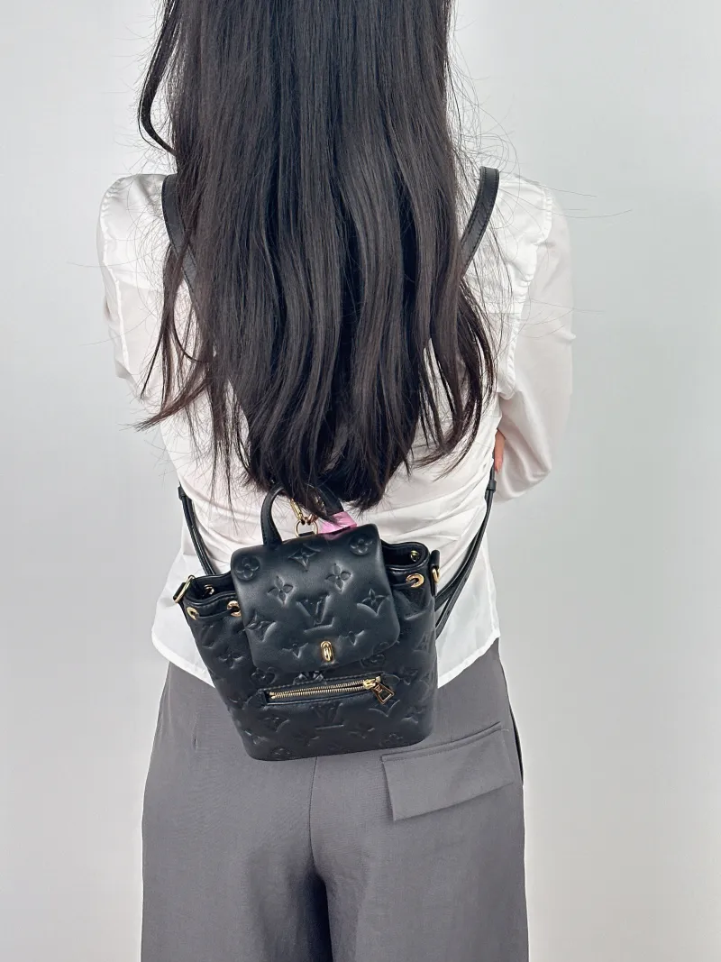 Louis Vuitton Backpack Coussin Backpack Black with Gold-Tone Hardware Lambskin Mini 15 × 7.5 × 20 cm — on-model view 1 of 2