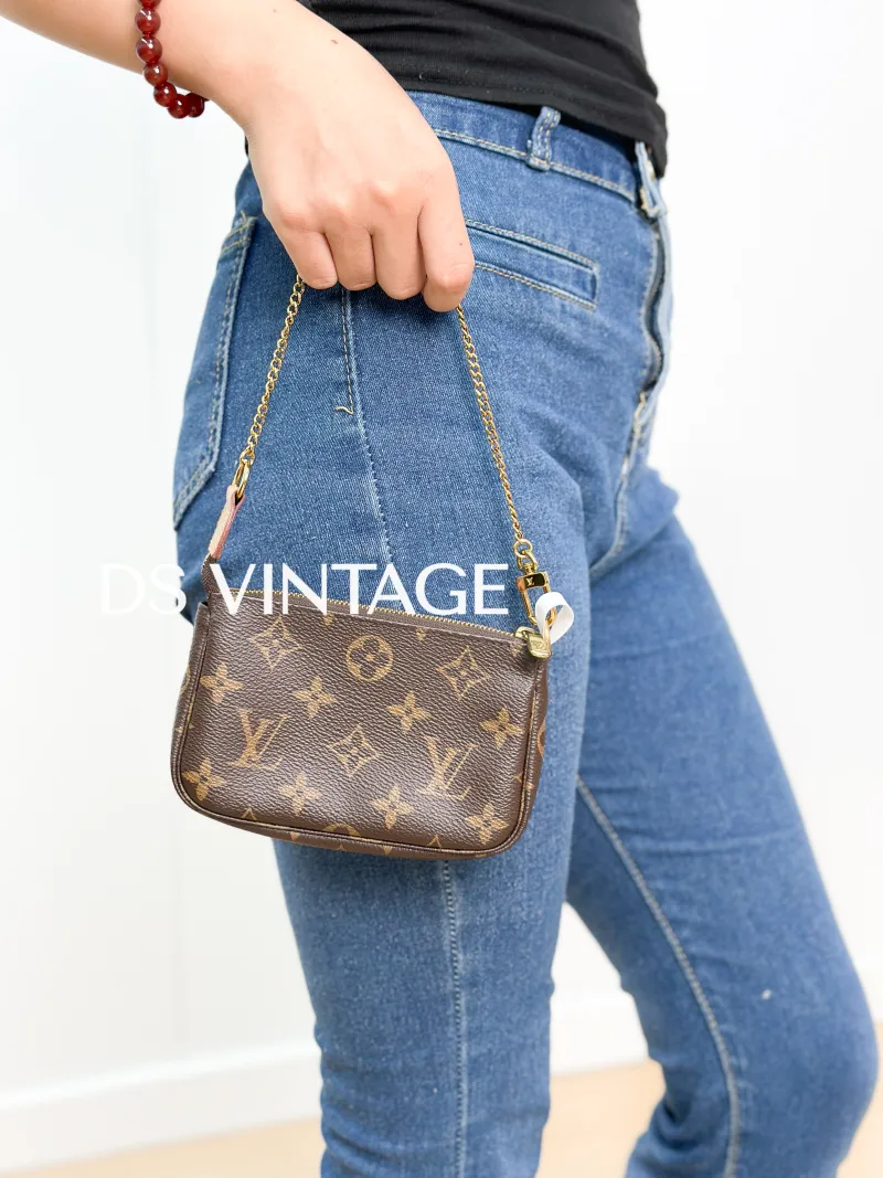 Louis Vuitton Clutch Mini Pochette Accessoires Monogram PVC Mini 15.5 × 4 × 10.5 cm — on-model view 3 of 3