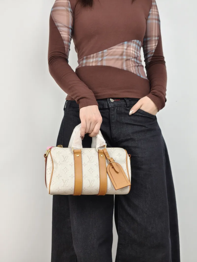 Louis Vuitton Crossbody Bag Keepall 25 White Monogram PVC Medium 25 × 11 × 15 cm — on-model view 3 of 3