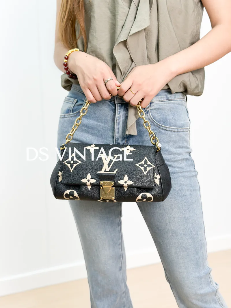 Louis Vuitton Crossbody Bag Favorite Black · White Empreinte Embossed Calfskin Medium 24 × 9 × 14 cm — on-model view 1 of 3