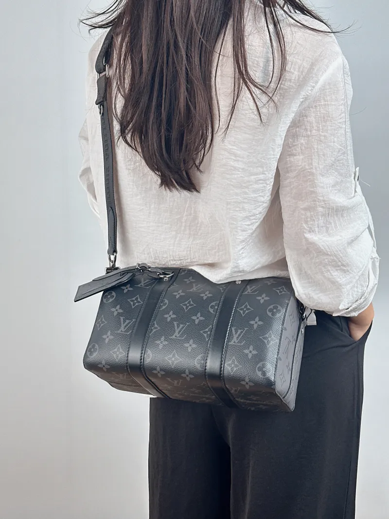 Louis Vuitton Crossbody Bag City Keepall Black PVC Medium 27 × 13 × 17 cm — on-model view 2 of 2