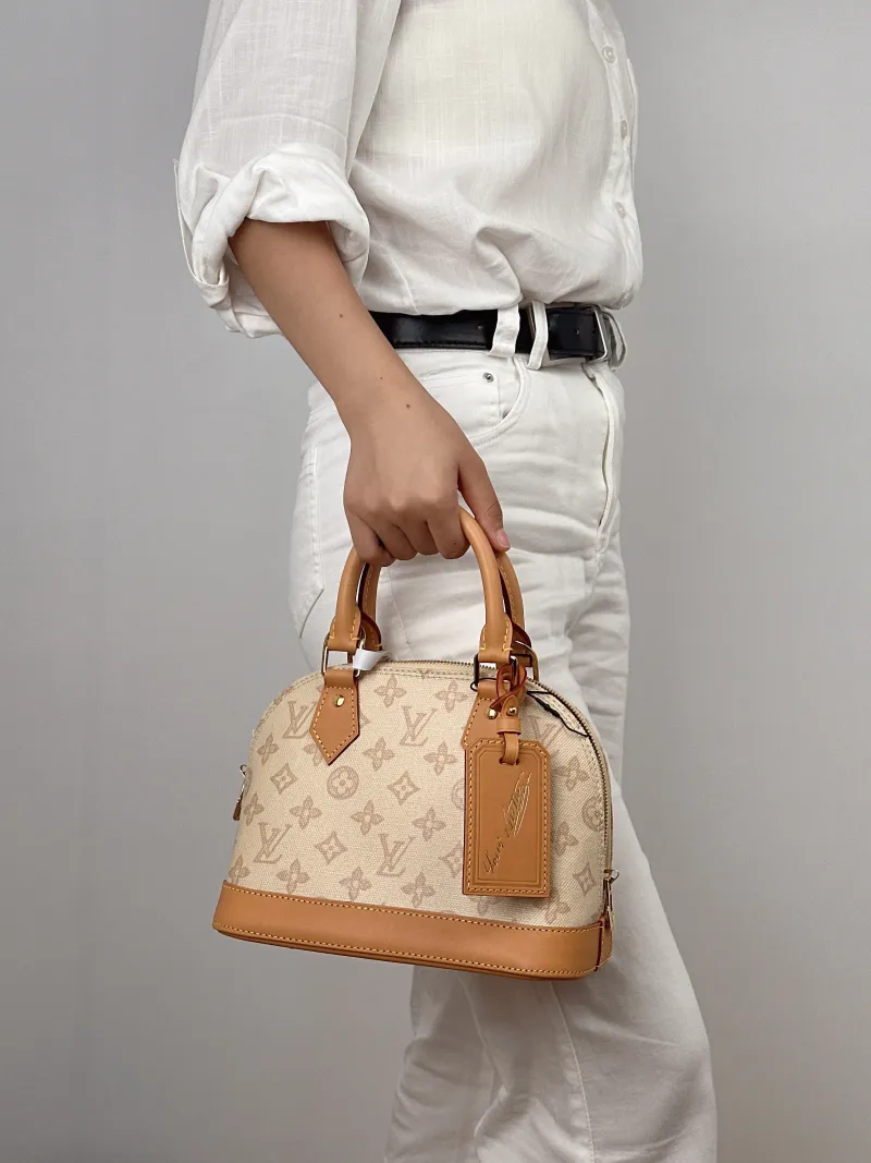 Louis Vuitton Top Handle Bag Alma BB PVCBB23.5 × 11.5 × 17.5 cm — on-model view 1 of 2