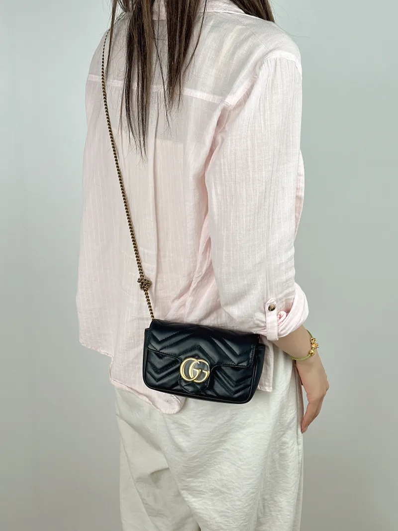 GUCCI Crossbody Bag GG Marmont Mini Marmont Mini Black Calfskin Mini 16.5 × 4.5 × 9.5 cm — on-model view 1 of 2