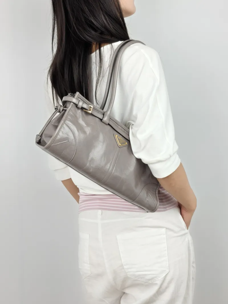 PRADA Shoulder Bag Bonnie Soft Lux Grey Waxed Leather Calfskin Medium 32 × 12 × 15.5 cm — on-model view 1 of 3