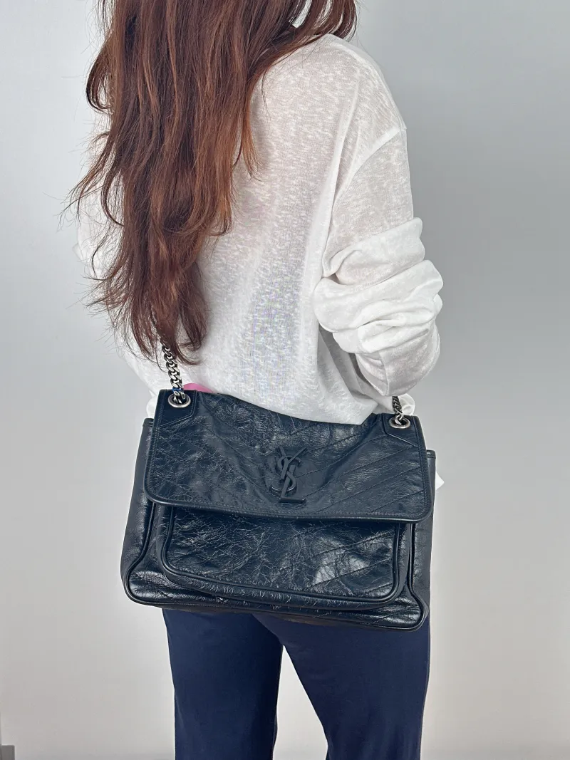 SAINT LAURENT Crossbody Bag Niki Black Waxed Leather Calfskin Medium 28 × 8.5 × 20 cm — on-model view 2 of 2