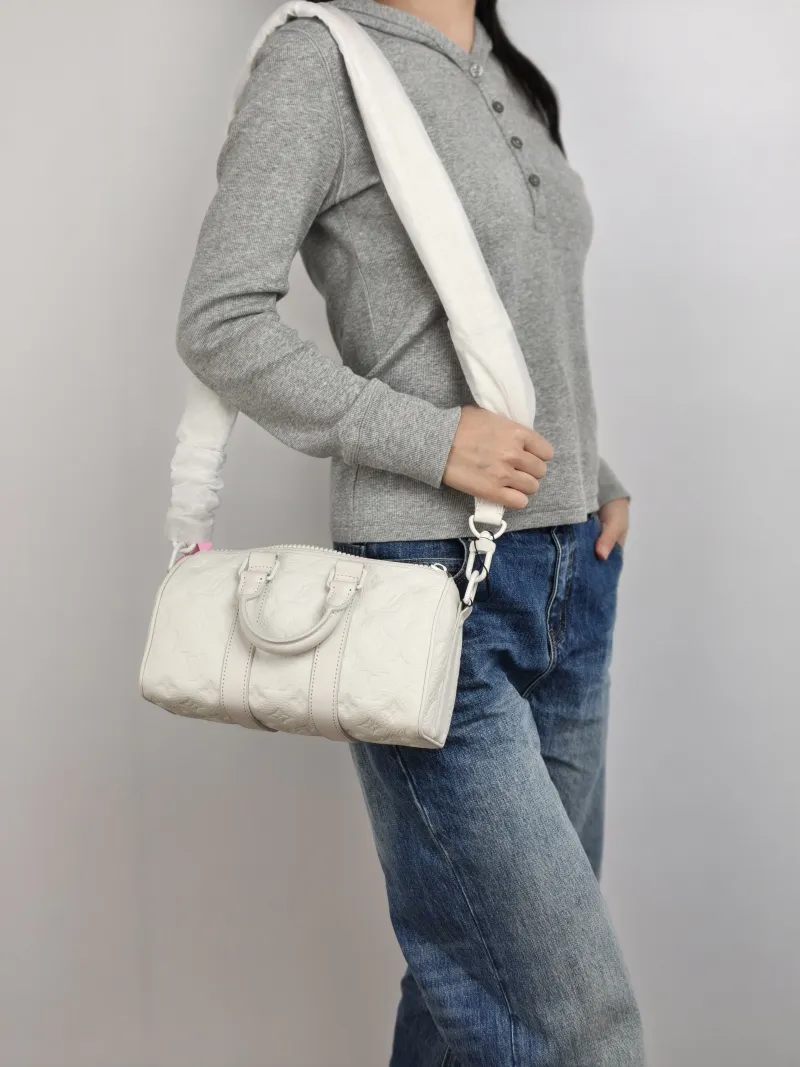Louis Vuitton Crossbody Bag Keepall 25 White Calfskin Medium 25 × 11 × 15 cm — on-model view 2 of 3