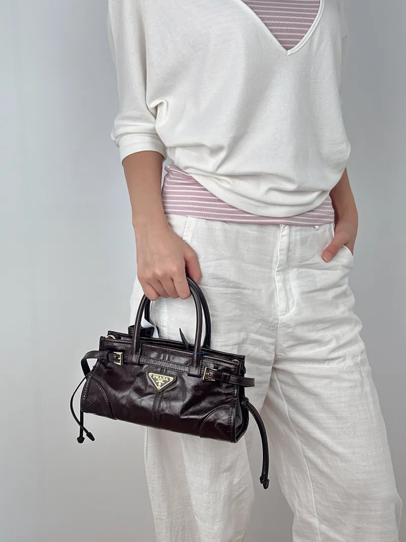 PRADA Top Handle Bag Bonnie Soft Lux Brown Waxed Leathermini23.5 × 9 × 12 cm — on-model view 2 of 3