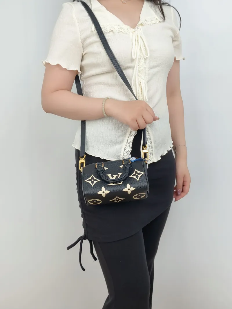 Louis Vuitton Crossbody Bag Speedy Nano Black · White Empreinte Embossed Calfskin Monogramnano16 × 7.5 × 10 cm — on-model view 1 of 3