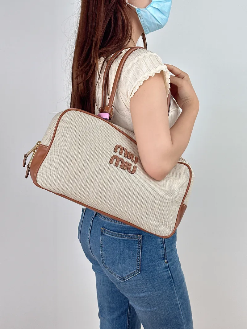 Miumiu Top Handle Bag Beau Brown Canvas · Calfskin Large34 × 10 × 20 cm — on-model view 1 of 2