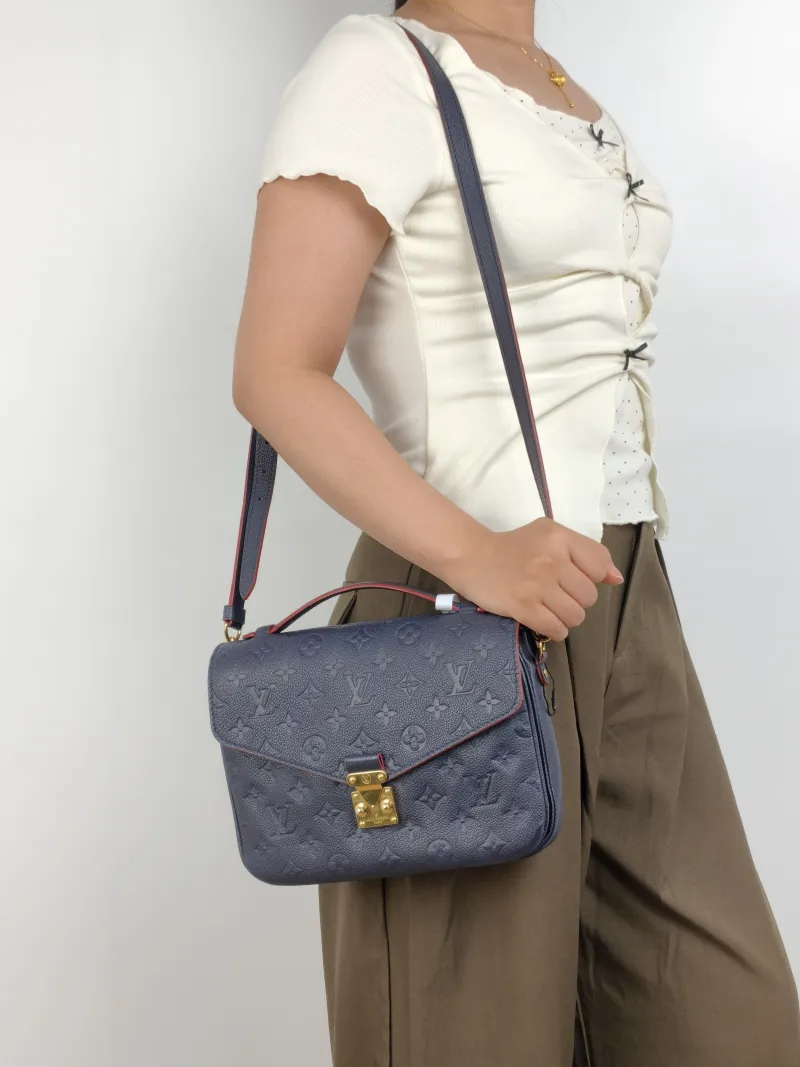 Louis Vuitton Crossbody Bag Pochette Métis · Monogram Empreinte Embossed Calfskin Medium 25 × 7 × 19 cm — on-model view 2 of 3