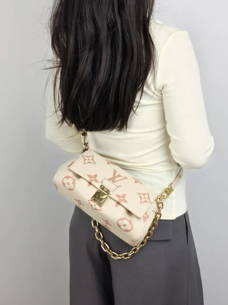 Louis Vuitton Crossbody Bag Favorite White · Pink Empreinte Embossed Calfskin Medium 24 × 9 × 14 cm — on-model view 2 of 3