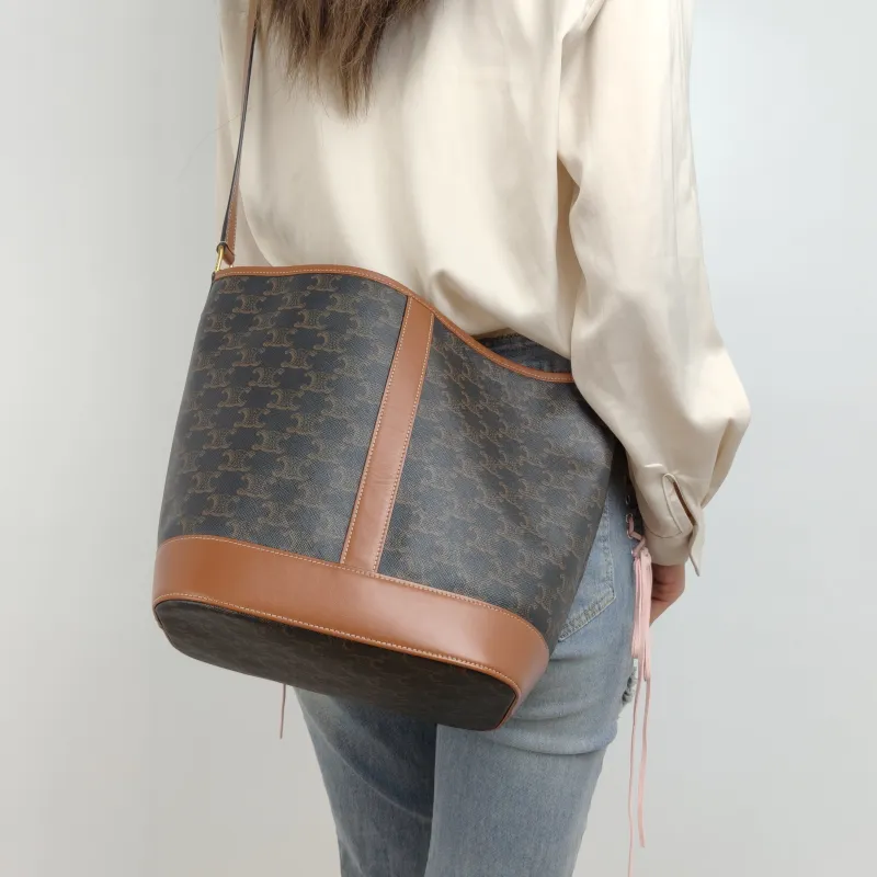 CELINE Crossbody Bag Triomphe Bucket Bag Monogram PVC Medium 24 × 18 × 27 cm — on-model view 1 of 2
