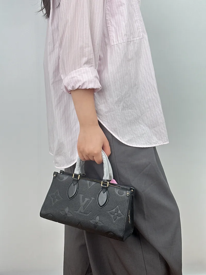 Louis Vuitton Crossbody Bag Onthego East West Two Straps Black Empreinte Embossed Calfskin Small 25 × 10 × 13 cm — on-model view 1 of 2