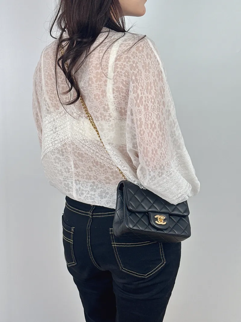 Chanel Crossbody Bag Black with Gold-Tone Hardware Lambskin Mini 17 × 8 × 12 cm — on-model view 1 of 2