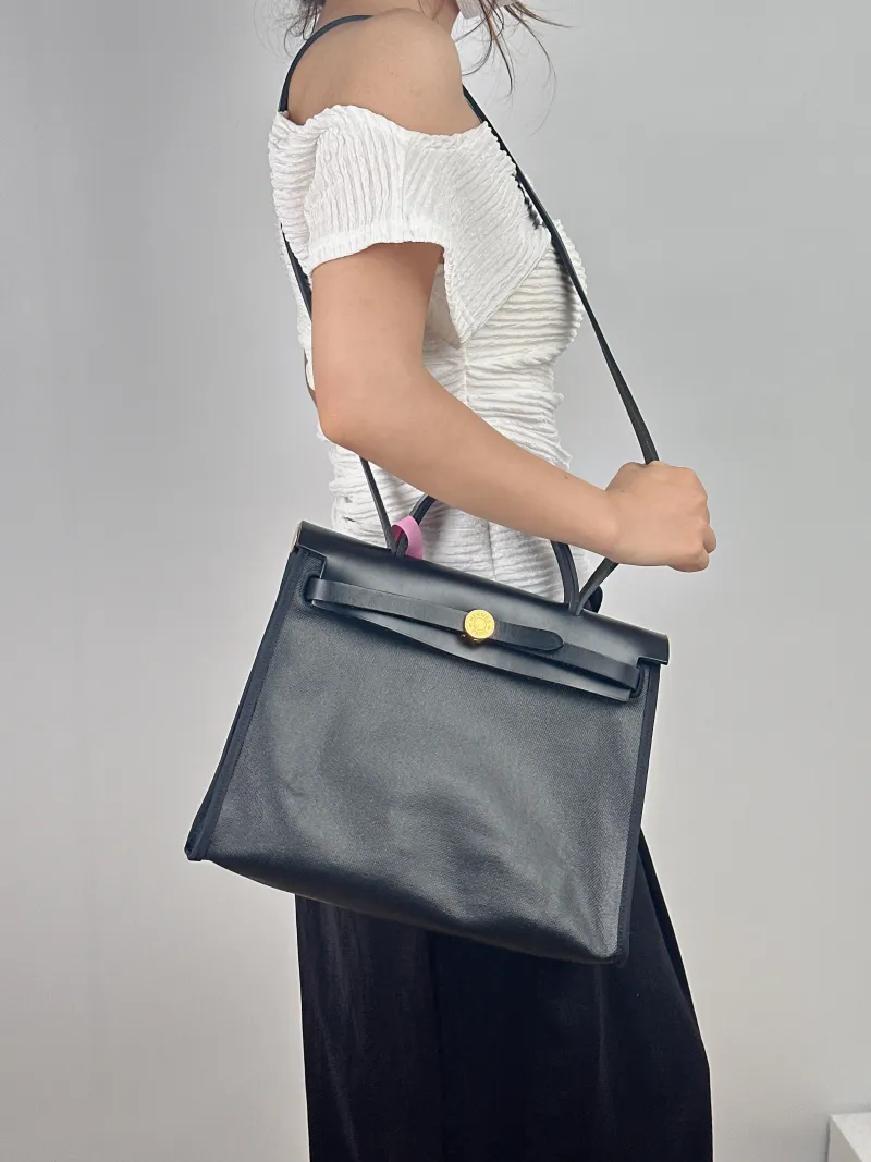 Hermès Crossbody Bag Herbag 31 Black Canvas Medium 30.5 × 11 × 25.5 cm W — on-model view 2 of 2